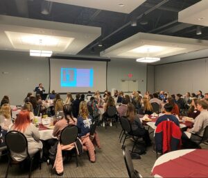 Large group at tables for presentation