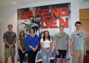 Six people standing in a hall