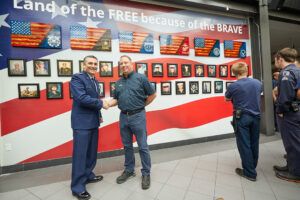 Four men in front of a veteran wall
