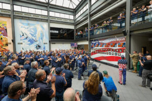 Large group unveiling a tribute wall