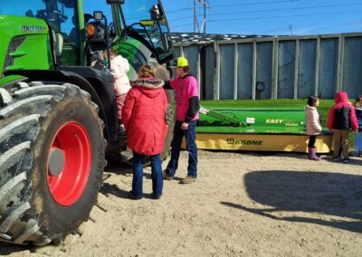 A group of children by a tractor
