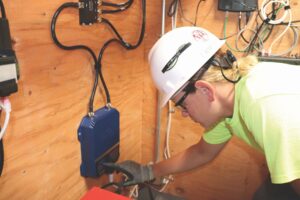 An electrician working on wires
