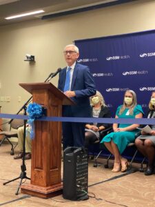 Governor Tony Evers speaking at a podium