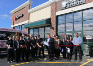 Large group of people at ribbon cutting