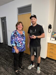 Two people. One with an award