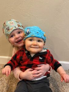 Two small children in surgical caps