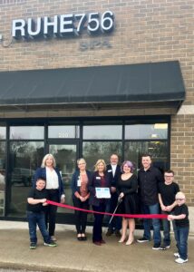 A group of people outside at a ribbon cutting