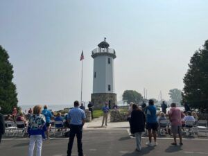 A crowd by a lighthouse