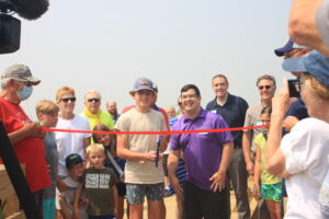 A large group at a ribbon cutting