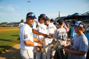 Baseball players signing autographs