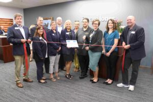 Large group of people at a ribbon cutting