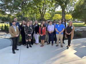 A large group outside for a ribbon cutting