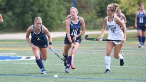 women playing field hockey