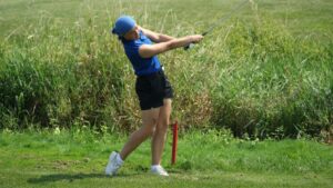 A woman playing golf