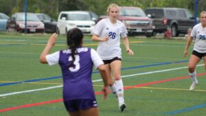 Three women playing soccer
