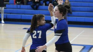 Two women playing volleyball