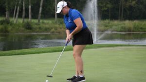 A woman playing golf