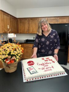 A woman with a cake and flowers