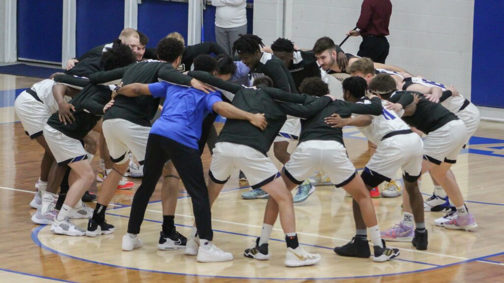 A large group of basketball players in a circle