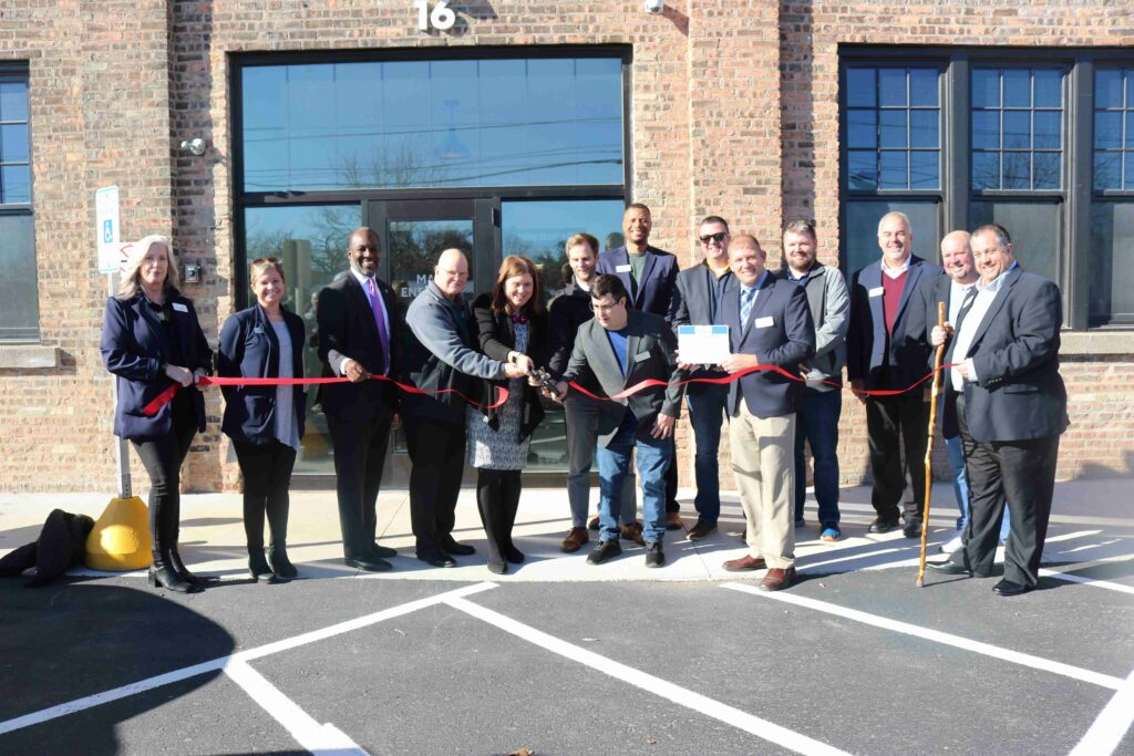 A large group outside at a ribbon cutting