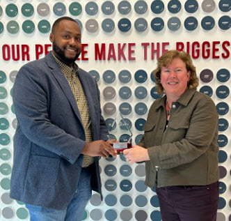 A man and a woman with one receiving an award