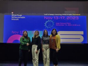 Four women on stage for an event