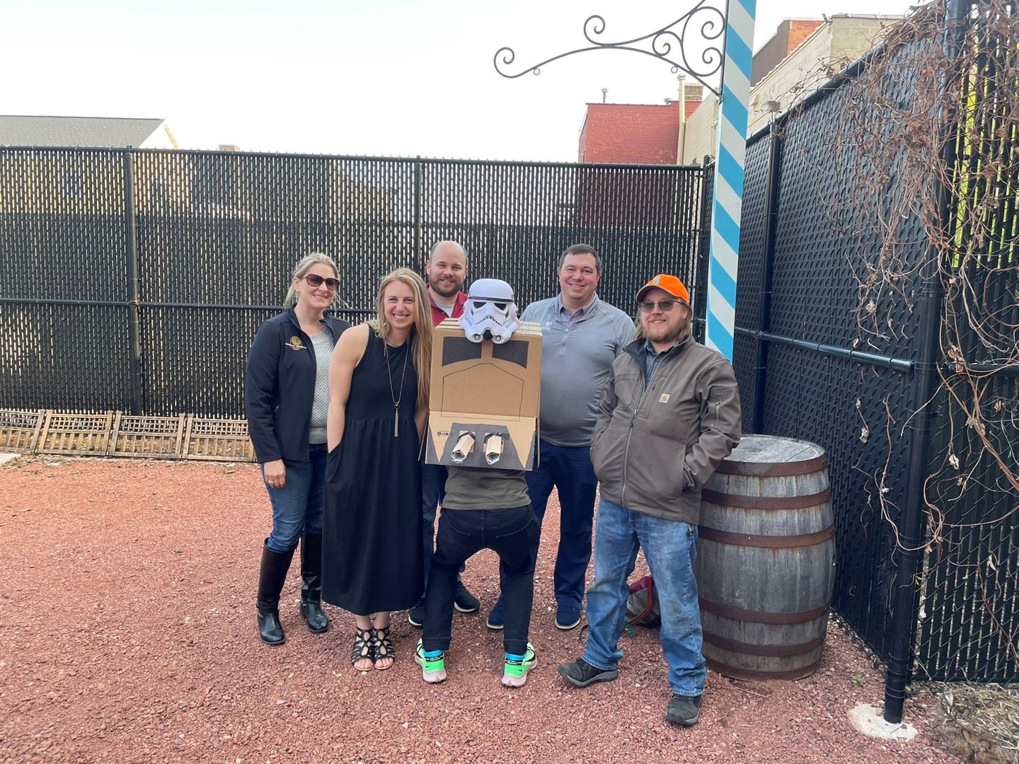 Five people outside with a person dressed as a stormtrooper