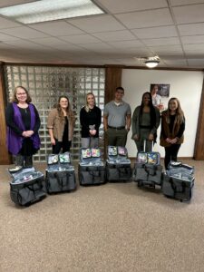 A group of six people with six bags