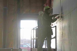 Two construction workers working on remodel