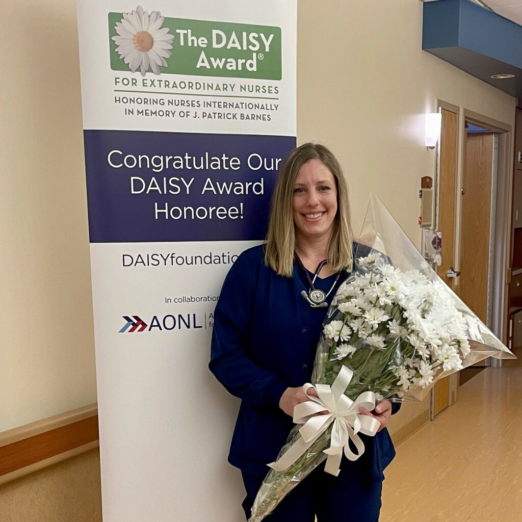 A nurse holding a bouquet of flowers