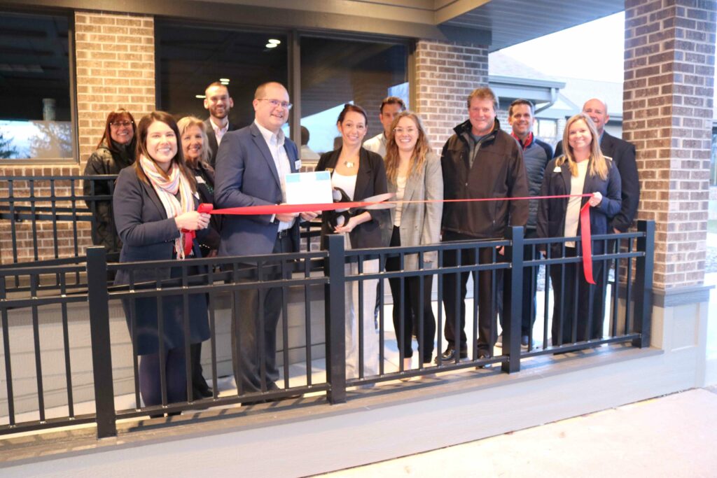 A large group outside at a ribbon cutting