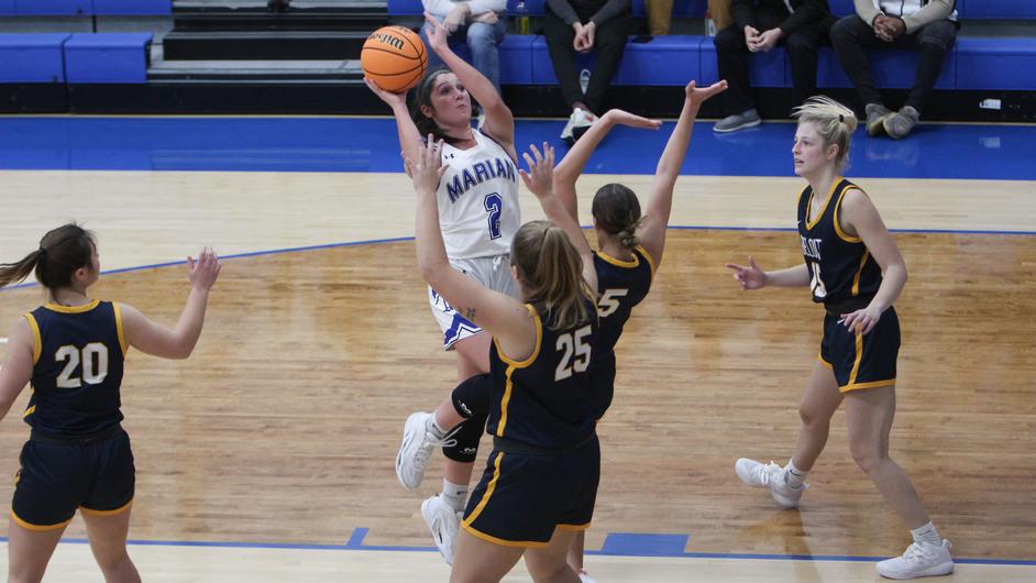A group of women playing basketball