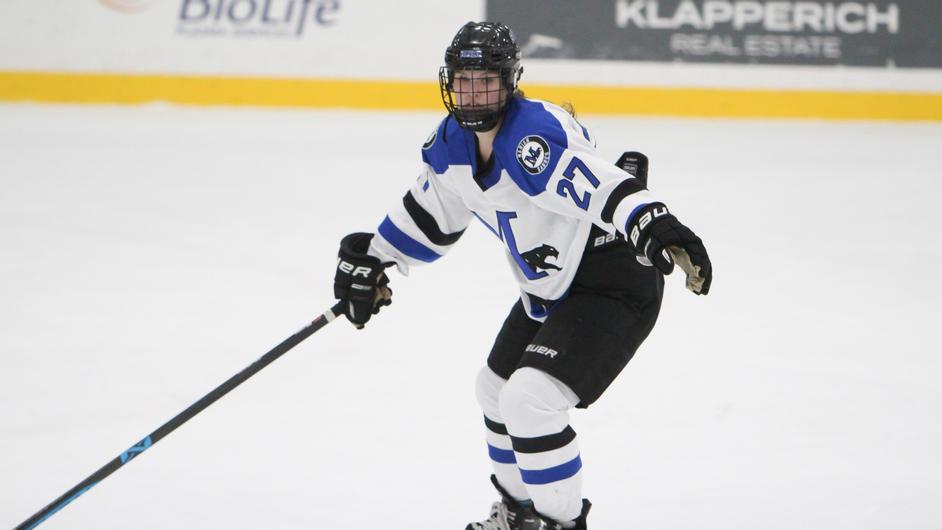 A woman playing hockey