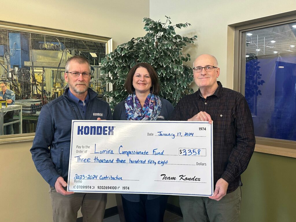 Three people holding a big check