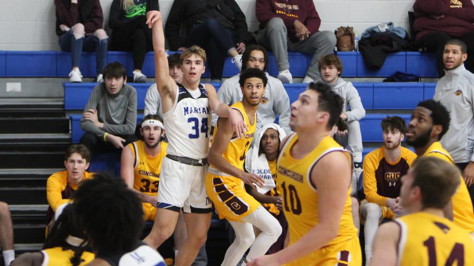 A group of men playing college basketball