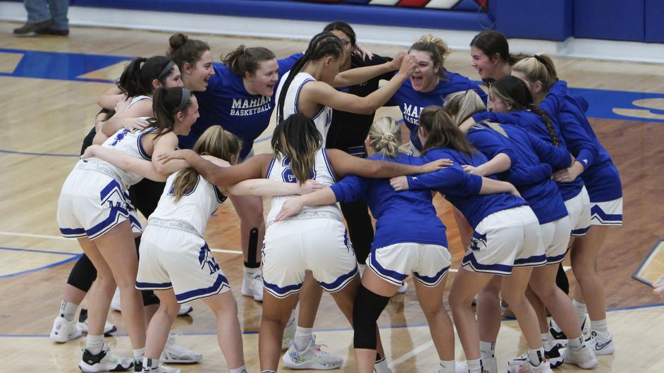 A group of female basketball players celebrating