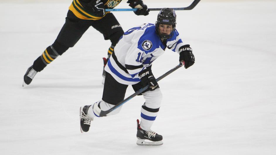 Two women playing college hockey