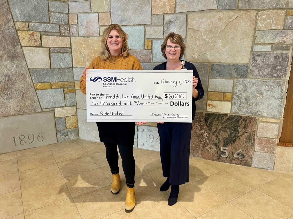 Two people with a big check