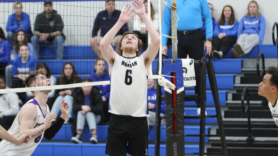 Men playing college volleyball
