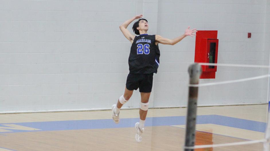 A man playing college volleyball