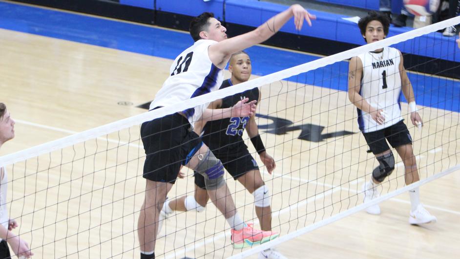 Men playing college volleyball