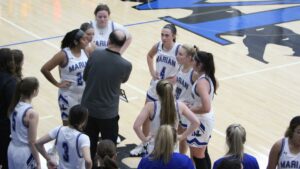 Women playing college basketball