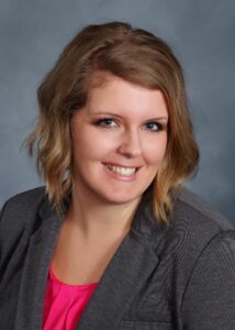 A business woman wearing a grey suit coat