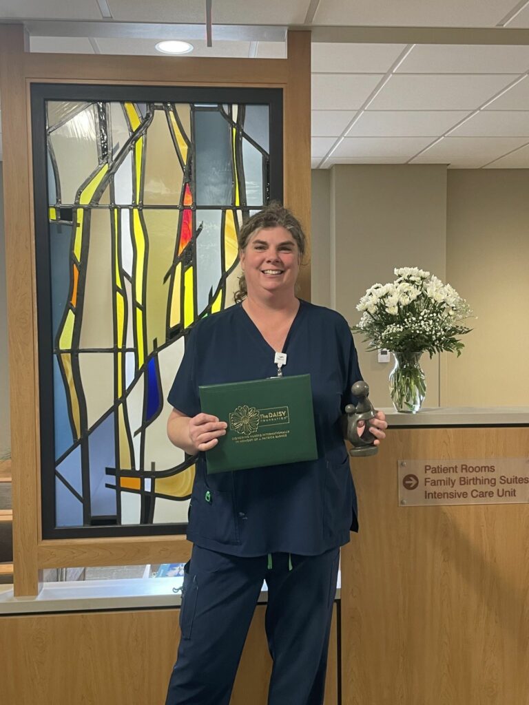 A nurse holding some flowers