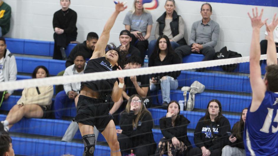 Men playing college volleyball