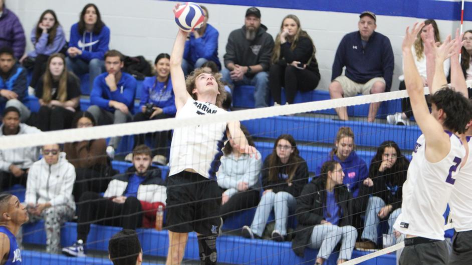 Men playing college volleyball