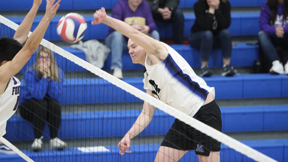 Men playing college volleyball