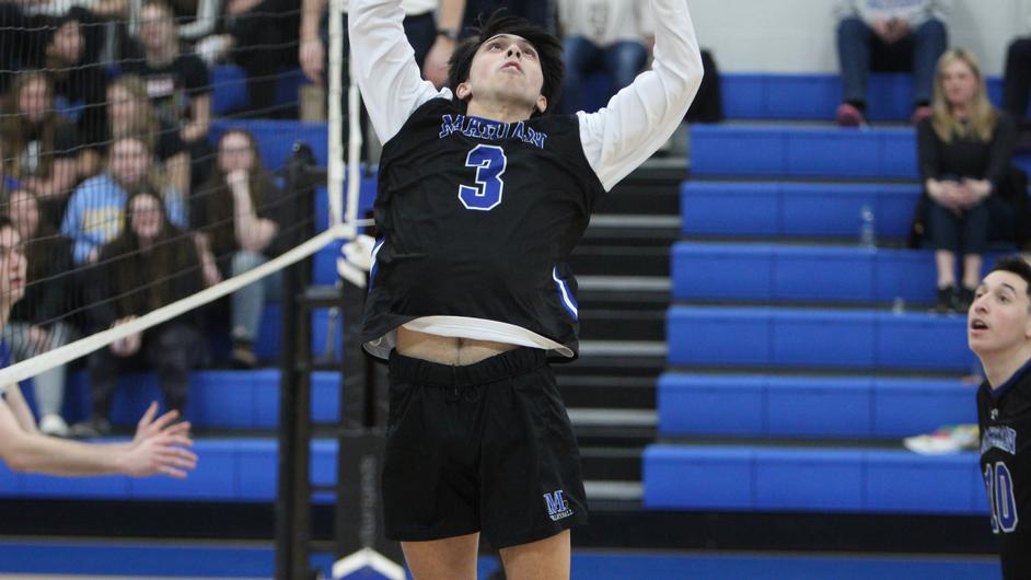 A man playing college volleyball