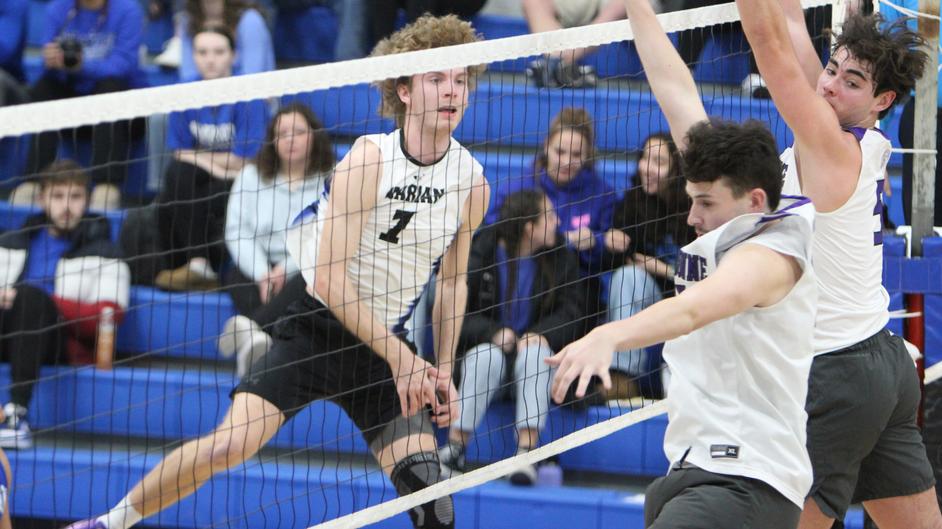 Men playing college volleyball