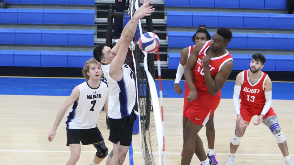 Men playing college volleyball
